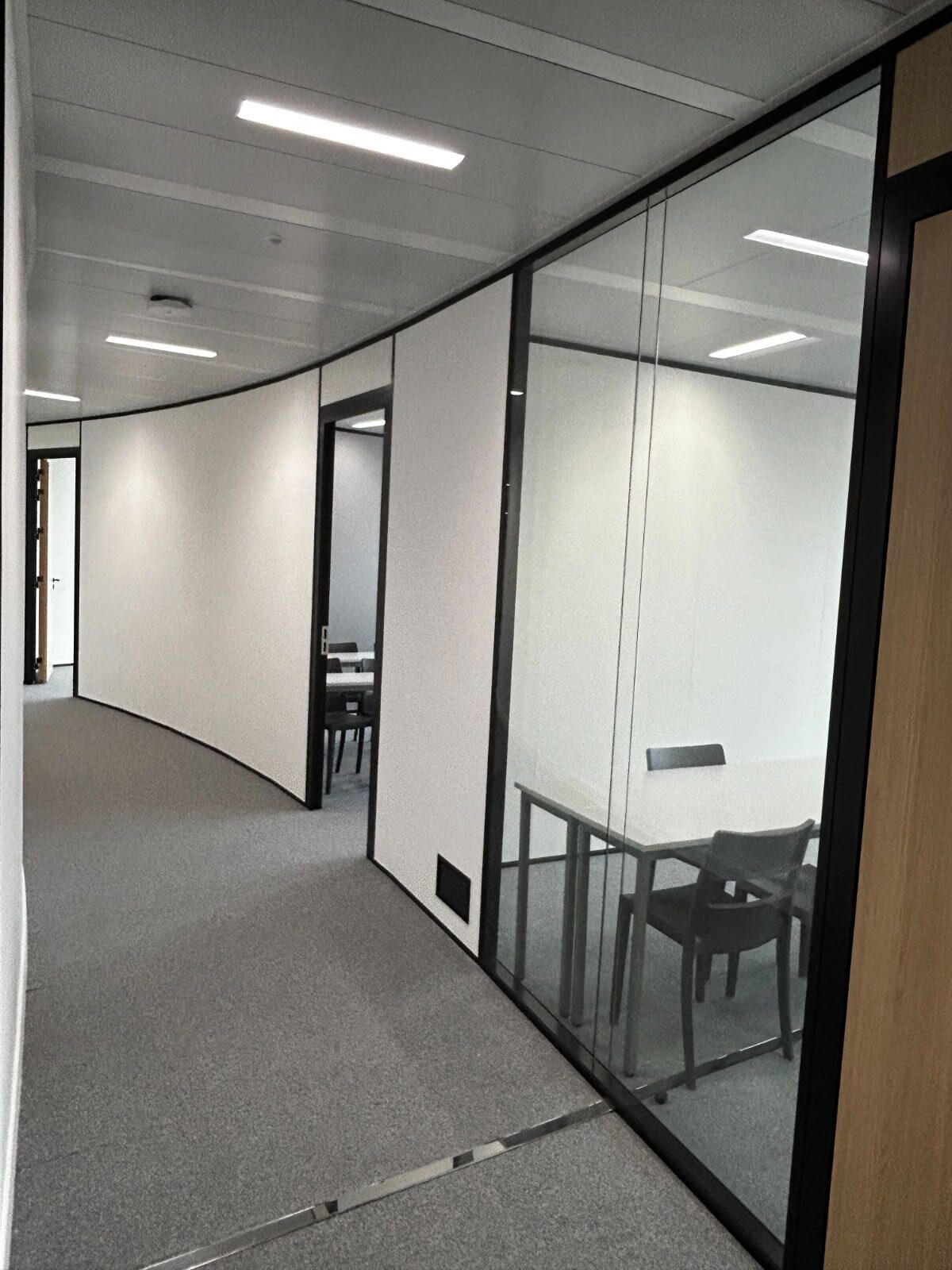Glass-partitioned study rooms inside the campus